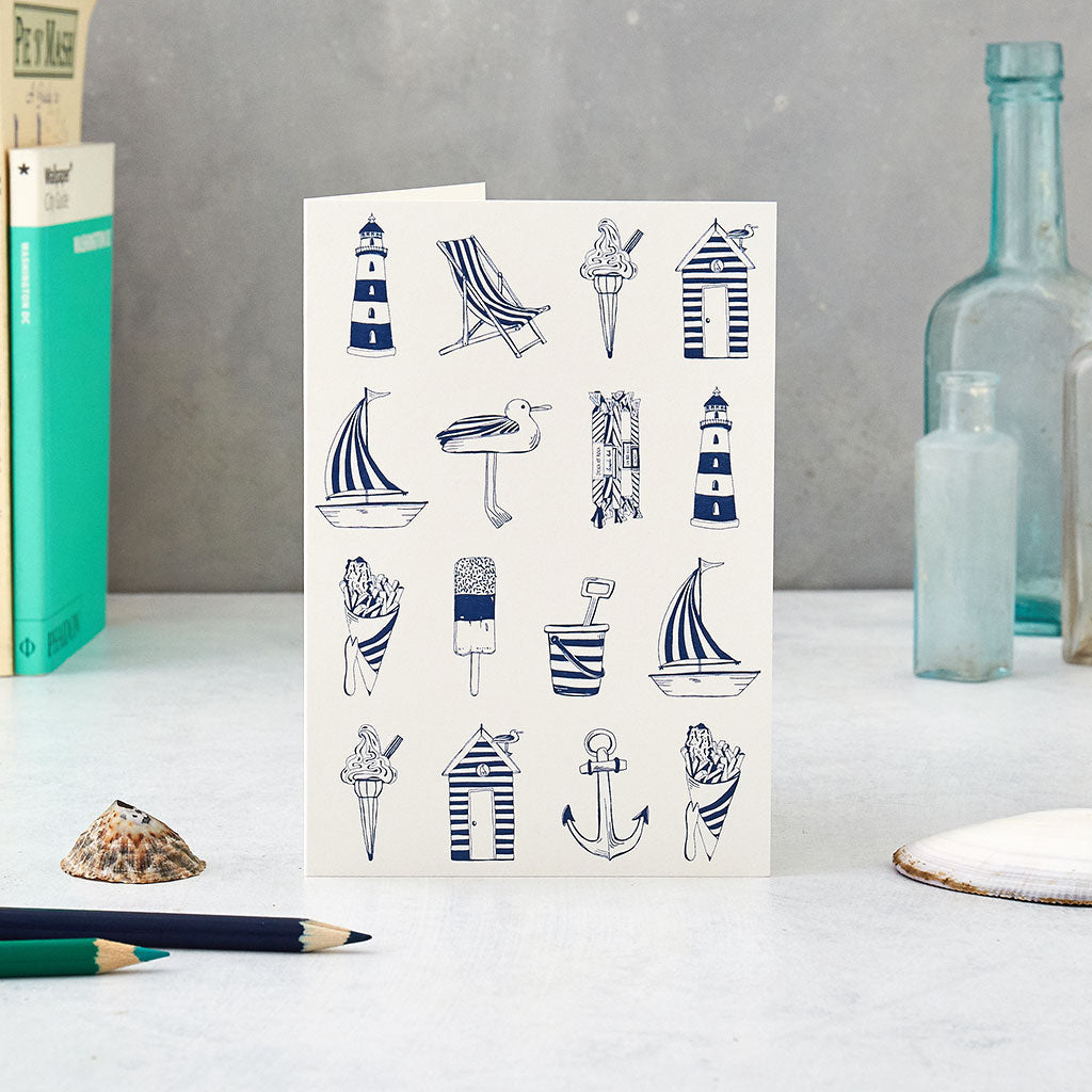 Greeting card featuring repeating nautical design in navy and white, Nautical greeting card featuring nautical icons such as a sailboat and light house, Navy nautical design greeting card featuring repeating nautical icons design 